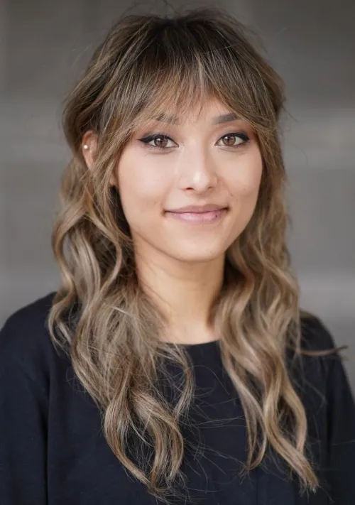 Long Choppy Layers and Wispy Bangs Beach Waves with Angled Wispy Banged