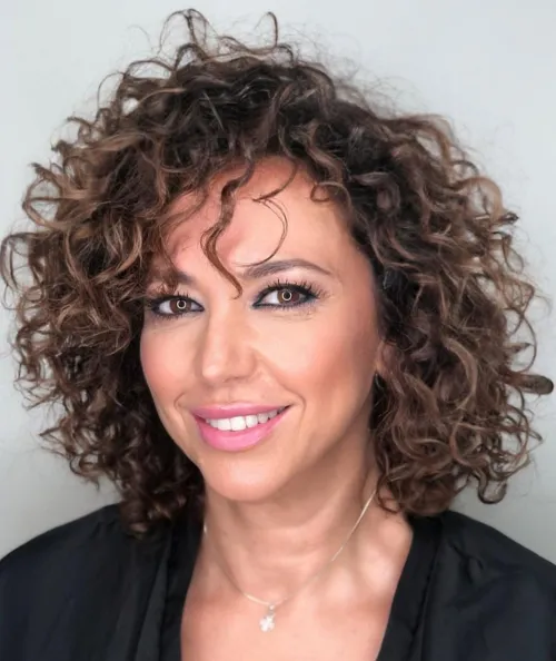 Chic Layered Cut for Fine Curly Hair Curly Layered Bob with Caramel Balayage