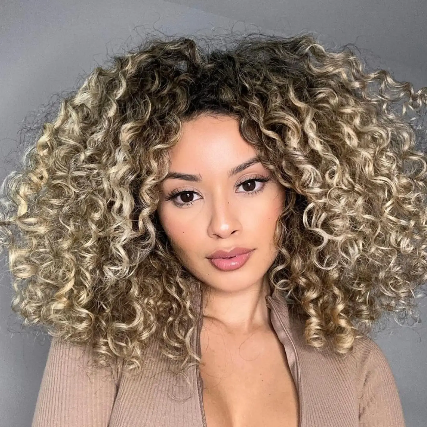 Columinous Curly Hairstyle with ASh and Sandy Blonde Highlights