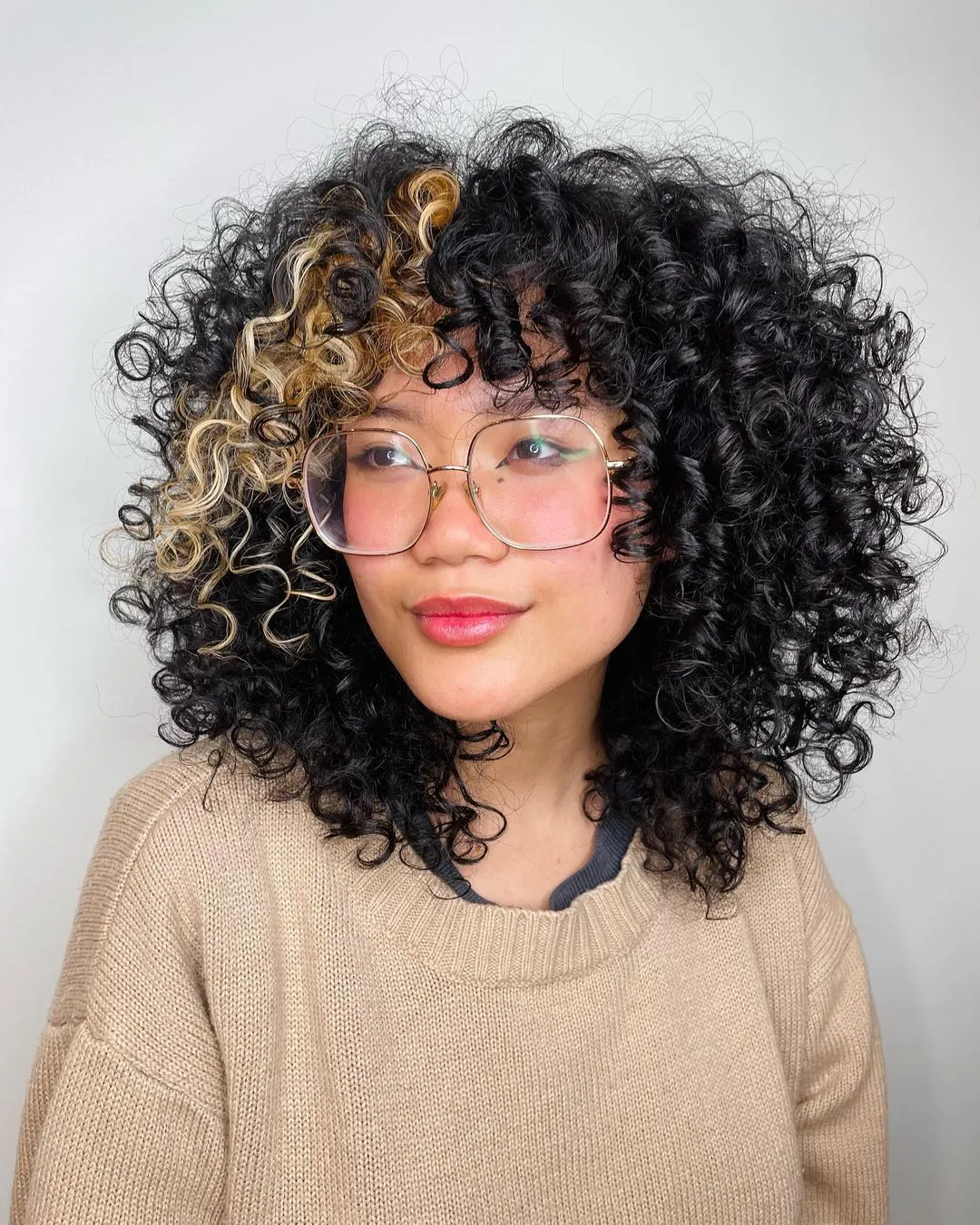 Black Curly Bob with Blonde Color Block on Bangs