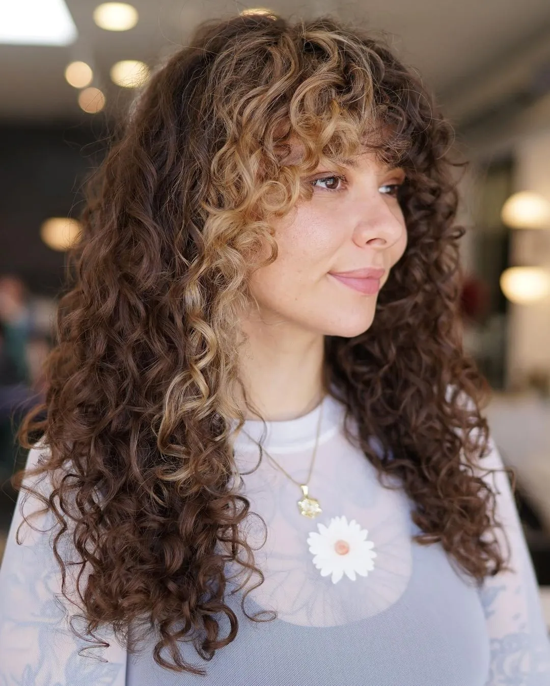 Layered Curly Hairstyle with Highlighted Bangs