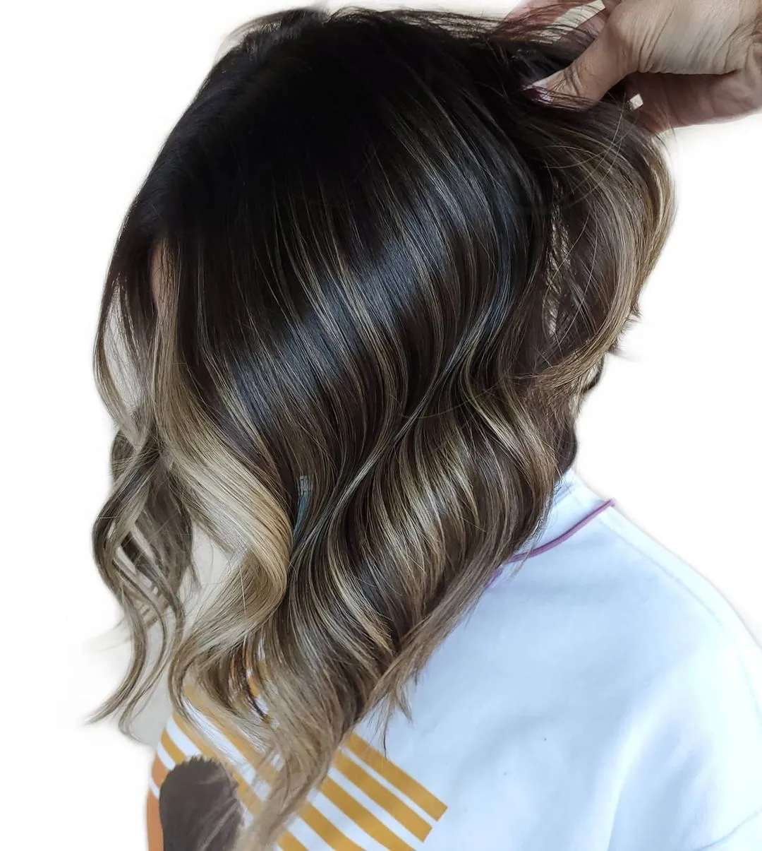 Metallic White Curly Hair in a Short Angled Stacked Cut