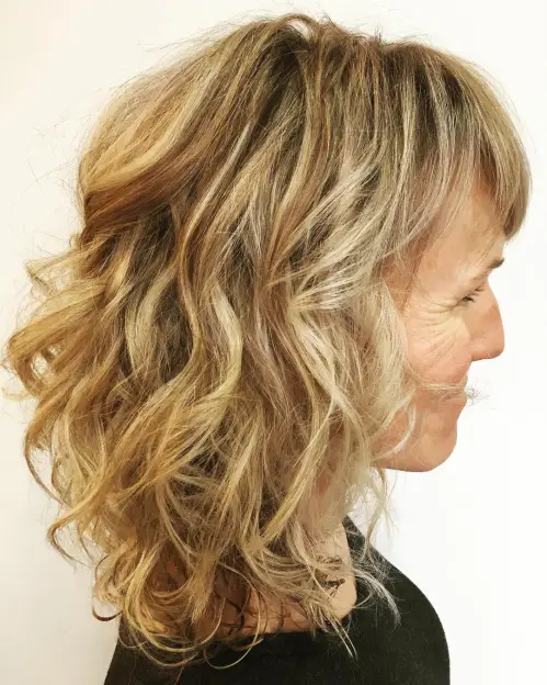 Medium Curly Hairstyle With Bangs