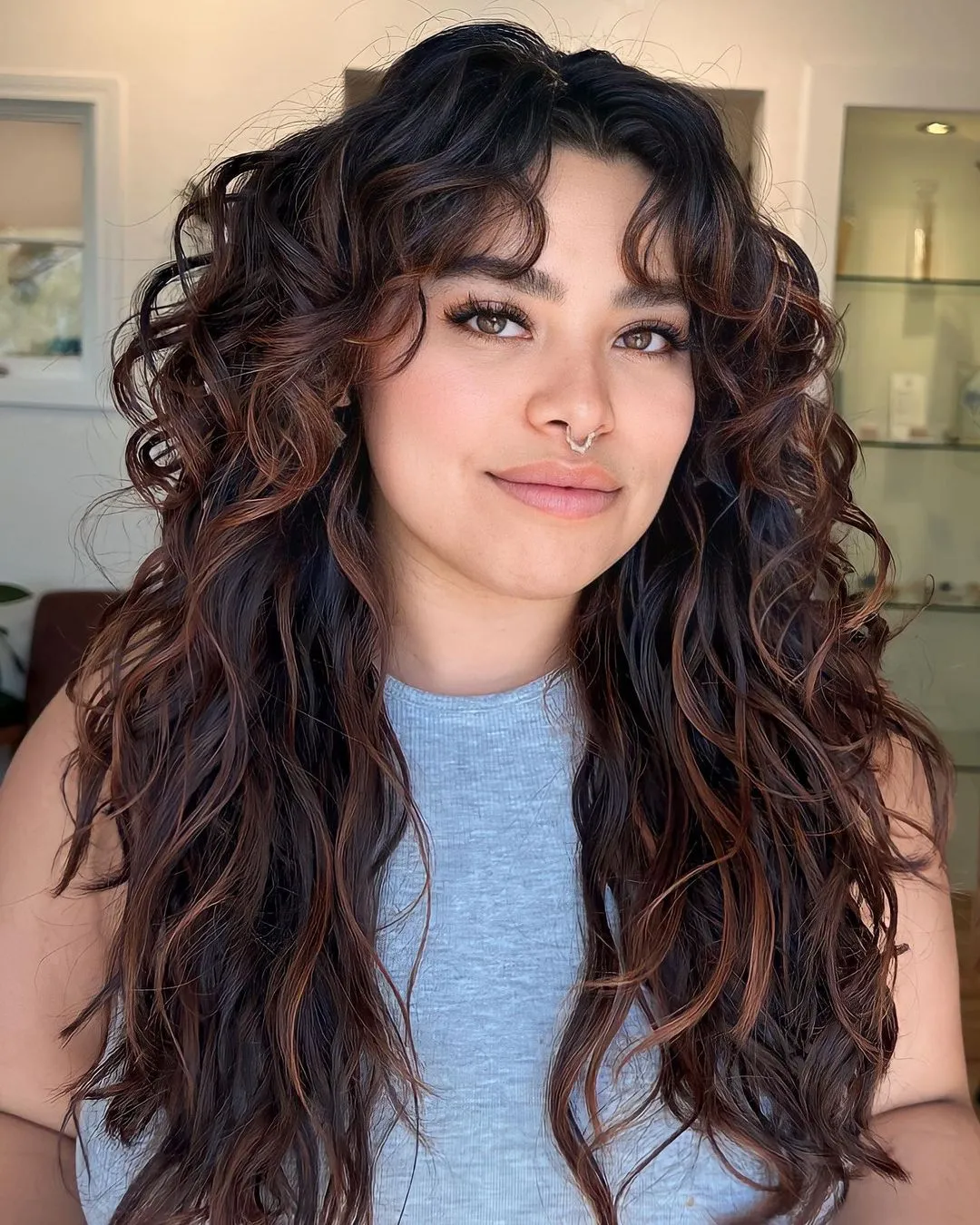 Long Waves with Fall-Themed Highlights Brunette Wavy Hair with Auburn Highlights
