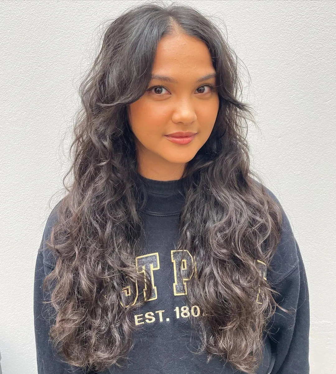 Long Waves with Soft Curtain Bangs Long Wavy Locks and Curtain Bangs for Brunettes