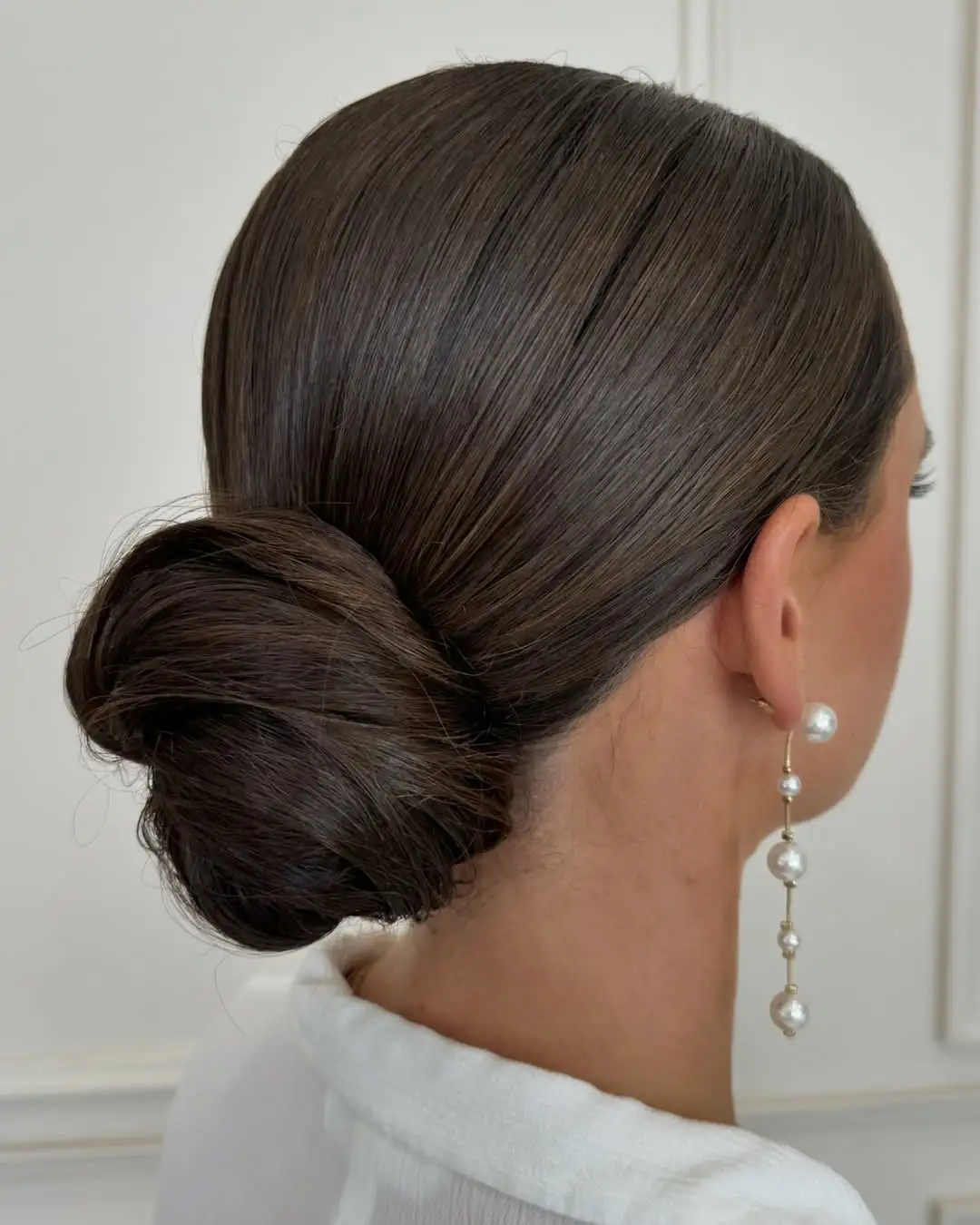 Slicked-Back Bun Sleek Updo for Oblong Faces