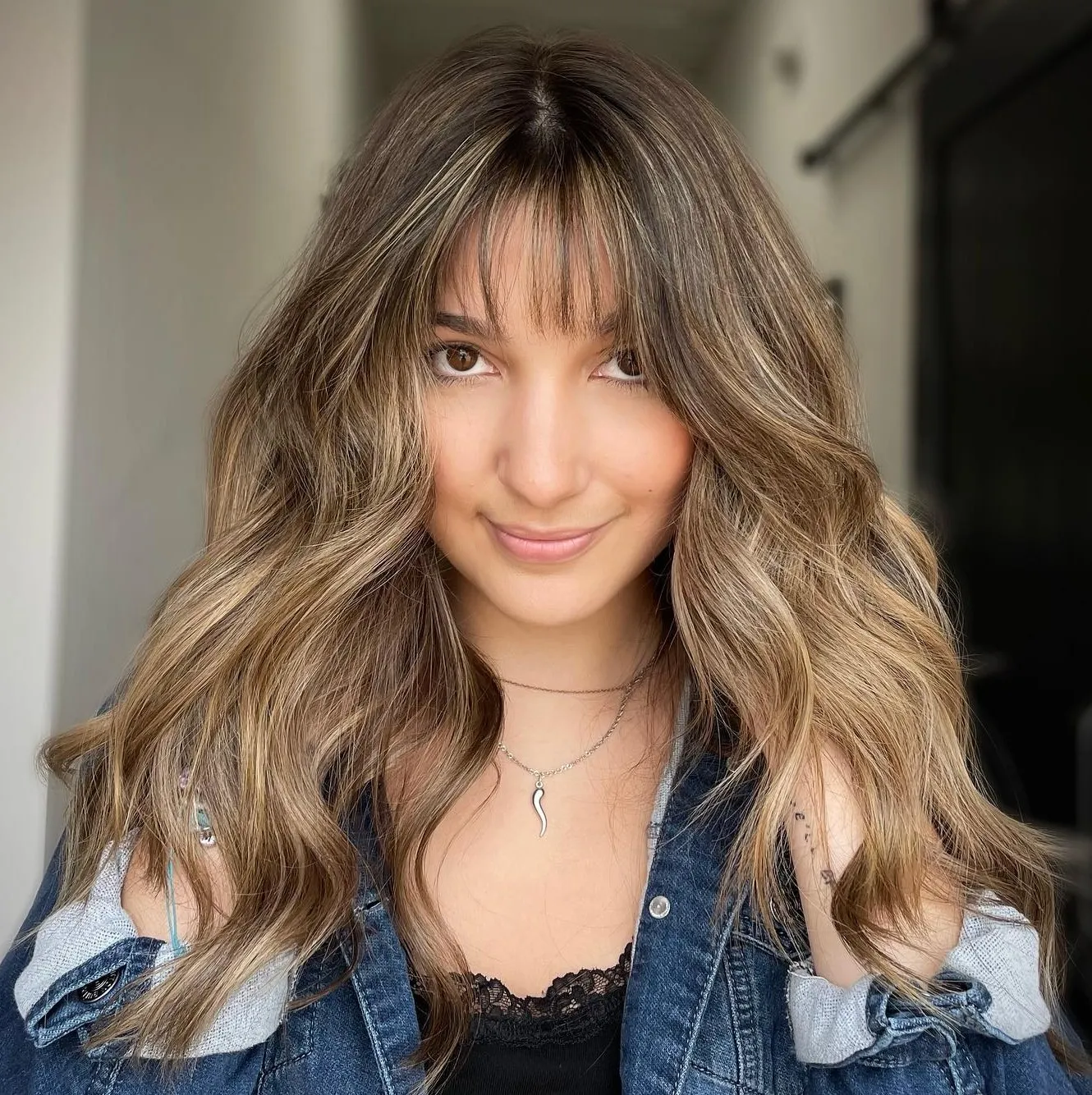 Medium Haircut with Thin Bangs and Highlights