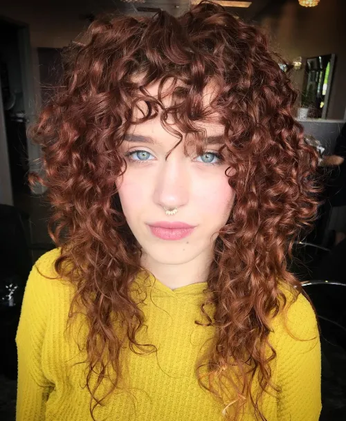 Long Layered Curly Haircut with Bangs